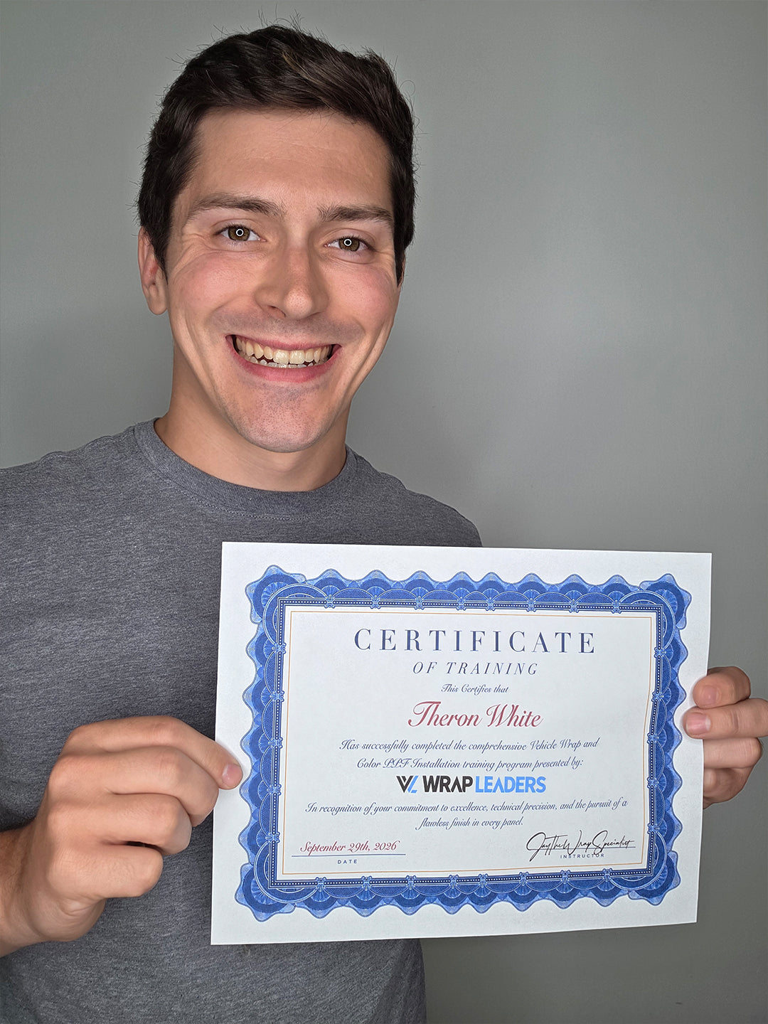 Theron White holding Vehicle Wrap and Color PPF training certificate